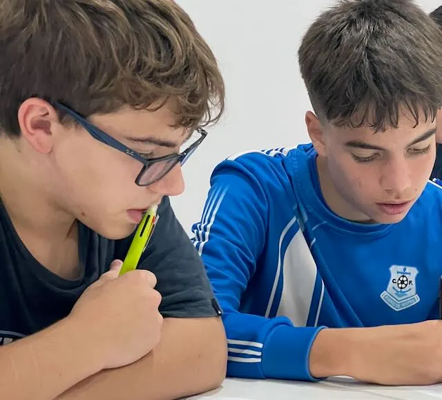 Dos alumnos adolescentes de Ella's English mostrando con orgullo sus certificados Cambridge