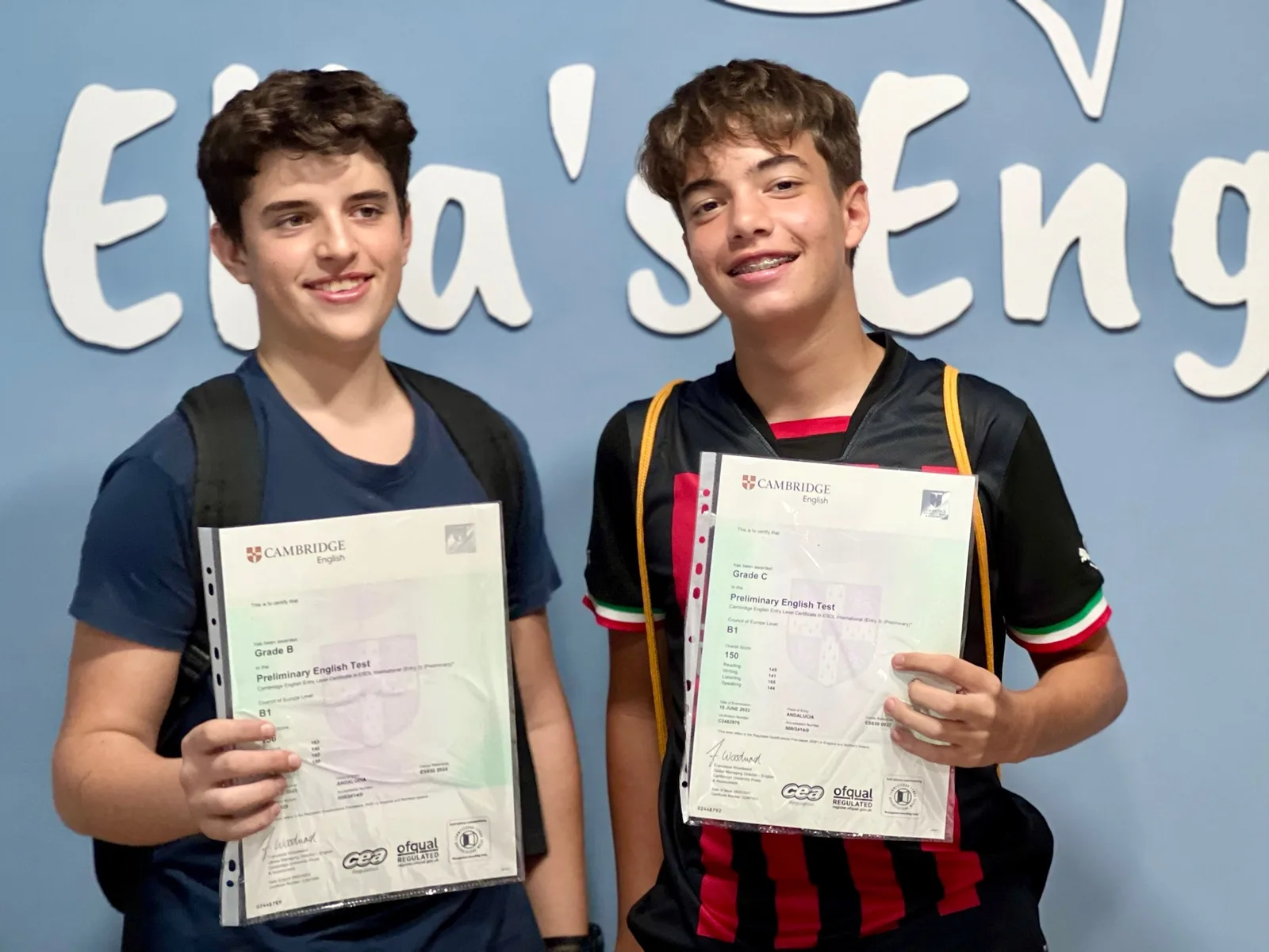 Two Ella's English students holding their Cambridge Preliminary English Test certificates
